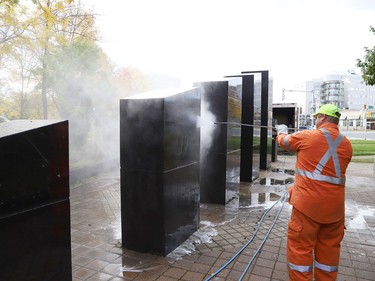 Marcel Berthiaume, of Environmental 360 Solutions, uses a power washer and cleaning agent to remove graffiti from black granite sculptures located at Hnatyshyn Park near Lloyd Street hill and Notre Dame Avenue in Sudbury, Ont. on Tuesday September 29, 2020. The granite monument and Trans Canada Trail walkway in the park were vandalized with graffiti sometime this past weekend. According to Anna Johnston, executive director of the Ukrainian Seniors' Centre, it happened sometime between Friday evening and Saturday morning. John Lappa/Sudbury Star/Postmedia Network