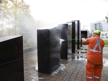 Marcel Berthiaume, of Environmental 360 Solutions, uses a power washer and cleaning agent to remove graffiti from black granite sculptures located at Hnatyshyn Park near Lloyd Street hill and Notre Dame Avenue in Sudbury, Ont. on Tuesday September 29, 2020. The granite monument and Trans Canada Trail walkway in the park were vandalized with graffiti sometime this past weekend. According to Anna Johnston, executive director of the Ukrainian Seniors' Centre, it happened sometime between Friday evening and Saturday morning. John Lappa/Sudbury Star/Postmedia Network