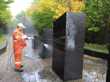 Marcel Berthiaume, of Environmental 360 Solutions, uses a power washer and cleaning agent to remove graffiti from black granite sculptures located at Hnatyshyn Park near Lloyd Street hill and Notre Dame Avenue in Sudbury, Ont. on Tuesday September 29, 2020. The granite monument and Trans Canada Trail walkway in the park were vandalized with graffiti sometime this past weekend. According to Anna Johnston, executive director of the Ukrainian Seniors' Centre, it happened sometime between Friday evening and Saturday morning. John Lappa/Sudbury Star/Postmedia Network