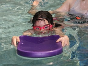 Erin Coles, 7 in this file photo, works on her swimming with the assistance of swim instructor Melodie Serre at the R.G. Dow Pool in Copper Cliff.