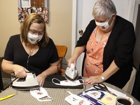 Joanne Hagger-Perritt, left, organizer of the local Kidney Walk event, along with her mom, Jacky Miller, were ironing some masks for bearing the name of her team in preparation for the virtual fundraising walk for the Kidney Foundation of Canada on Sunday, Sept. 27. 

RICHA BHOSALE/The Daily Press
