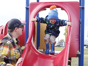 Lucas Deraiche, 3, emerges from opening at the top of the slide at Hollinger Park with encouragement from his dad Adam.  Thursday should be another fine day to play in the park with a mix of sun and cloud and a daytime high of 14 C expected.

RICHA BHOSALE/The Daily Press