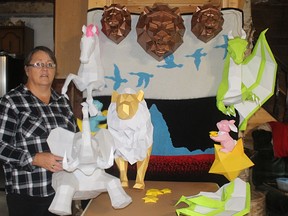 Betty Tousignant stands in front of some of the sculptures she has made.TP.jpg