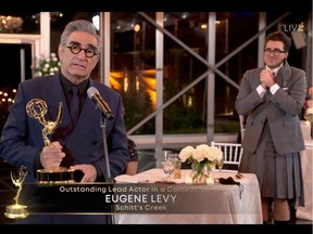 This handout picture released courtesy of Image Group LA / American Broadcasting Companies, Inc. / ABC shows host Canadian actor Eugene Levy speaks after receiving his Emmy while his son actor/director/writer Daniel Levy watches during the 72nd Primetime Emmy Awards ceremony held virtually on September 20, 2020.