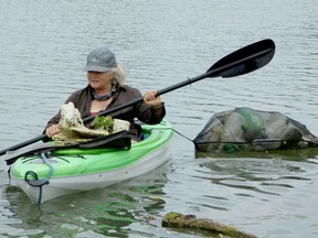 Sally Joyce, on one her frequent garbage clean-up kayak trips on the Sydenham River, was photographed on Sept. 2. She takes trips a couple times every week to try and protect wildlife and clean the littered shorelines. Sandy Baird photo