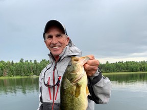 Jim Gustafson with a big largemouth bass he caught while pre-fishing for Bassin' For Bucks.  He is hoping to see this fish again on the weekend.