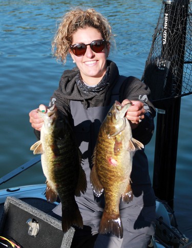Breanne Becker from Kenora is all smiles showing off show off some of her and partner's Bryan Gustafson haul during the second day of the 24th annual Bassin' For Bucks fishing tournament in Sioux Narrows on Saturday, Sept. 12.