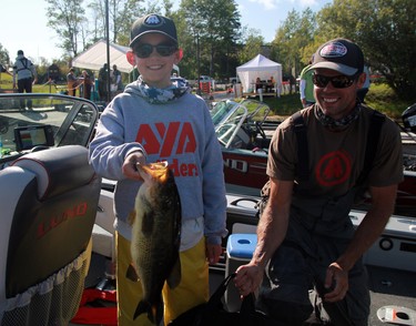 Bronson Beasant from Kenora shows off his catch of the day as father Blair looks on during the second day of the 24th annual Bassin' For Bucks fishing tournament in Sioux Narrows on Saturday, Sept. 12. Ryan Stelter/Miner and News