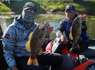 Carson, left, and Brennen Dubchak from Kenora show off a pair of fish from their 16.4-pound second day during the second day of the 24th annual Bassin' For Bucks fishing tournament in Sioux Narrows on Saturday, Sept. 12.