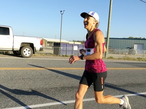 Dale Thacher smiles as she runs the virtual Boston Marathon on Highway 658 on Friday, Sept. 11.