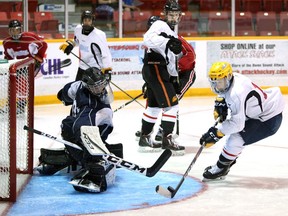 Centre Logan LeSage clears a puck behind goaltender Nicholas Von Kaufmann as the Owen Sound Attack opened rookie camp with practices, fitness testing and scrimmages inside the Harry Lumley Bayshore Community Centre in August, 2019. LeSage, an Under-18 Priority Selection pick of the Attack, earned a roster spot out of training camp, which may be tougher for unheralded players to do this year as teams trim camp rosters in response to COVID-19. Greg Cowan/The Sun Times