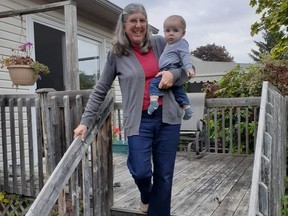 “I need to change the hand rails on my stairs to ensure my safety and my grandson's safety when I carry him,” says Nancy Edwards, pictured on the stairs with her six-month-old grandson. "A pincer grasp on my current handrail does not give me a strong enough grip."