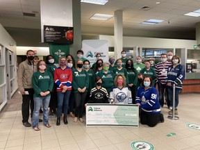 The Caisse Alliance branch on Cassells Street presents a $1,000 cheque to the family of Noah Dugas, Friday morning. Supplied photo