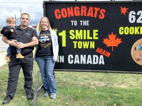 Ryan DiTommaso, his wife Sara, and son Rhett, celebrate Tim Hortons in Dunnville, Ont., selling the most Smile Cookies in Canada for a third consecutive year. SUPPLIED