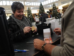 Donnelly resident Monique Jean-Cote buys a few Cars for Christmas lottery tickets from Swan City Rotary past-president Leo Lauzon at the Prairie Mall in Grande Prairie back in 2010.
