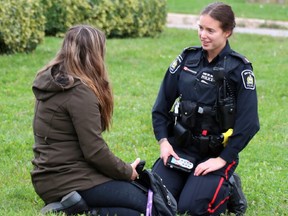 A Sault Ste. Marie Police Service officer speaks with a woman following a three-vehicle crash on Second Line West on Saturday. Brian Kelly