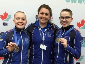 Sudbury Synchro Club coach Courtney Stasiuk stands between medal-winning swimmers Georgia Speck, left, and Stacie Kohan.