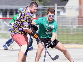 Chad Laroche (left) of Grapes' Grinders battles Tilbury Trailhawks' Patrick Mathews during a Chatham-Kent Road Hockey League game at the Chatham Memorial Arena parking lot on Sept. 27. The league is several years old but has become more popular this year because of the COVID-19 pandemic. Mark Malone/Postmedia Network