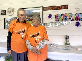 Cecil (left) and Delores Isaac at their 70th wedding anniversary on Sept. 30. Behind them is a picture of the 72-person family that all started with the couple. Jake Romphf