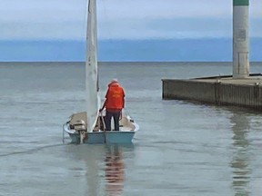 Reginald Fisher of Dutton, who vanished after his small sailboat capsized on Lake Erie, is seen on the 14-foot craft in the Port Glasgow harbour in September in an image taken by a restaurant worker there. Police on Oct. 5 said a body discovered in Port Burwell has been identified as that of Fisher’s. Supplied