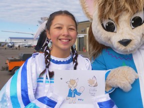 Mascot design contest winner Sadie Antonie holding her winning submission with the official mascot of the Wood Buffalo 2022 Arctic Winter Games, Nitotem. Supplied image/Arctic Winter Games Host Society