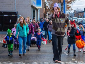 City Councillor Chris Thiessen leads the Halloween Parade down 100 Avenue with several hundred participating parents and children in tow in Grande Prairie, Alta. on Saturday, Oct. 26, 2019. JOHN WATSON/DAILY HERALD-TRIBUNE