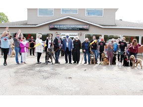 The opening of K-9 Headquarters was celebrated recently with a ribbon cutting ceremony at the Boundary Road location. President Jeff Hinch (sixth from left) cut the ribbon as he was joined by dignitaries, staff and supporters. Also taking part were Marianne Taylor (fourth from left) representing MPP John Yakabuski; Jen Hinch, regional manager for Renfrew County; Pembroke Mayor Mike LeMay; MP Cheryl Gallant and Norbert Berubé, father of Nancy Berube, vice-president and director of animal welfare, who recently passed away.