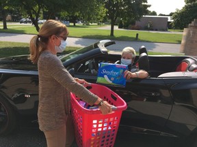 Marge Muharrem, left, of Women United, and Linda Reaume, president of the Chatham-Kent Labour Council, demonstrate how the drive-thru donation will work for Tampon Tuesday. (Handout)