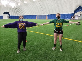 Danielle Stinson and Breanna Boisvenue demonstrate some physical distancing during a break in flag football action at the Lasalle Dome in Sudbury, Ontario on Thursday, October 15, 2020.