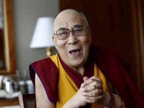 “A simple smile. That’s the start of opening your heart and being compassionate to others,” the Dalai Lama says. REUTERS/Denis Balibouse