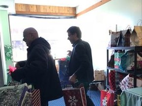 Last holiday season MLA Todd Loewen helped staff from Ruby's Variety store bring bags out to the van headed to seniors in Hines Creek and in Fairview.
