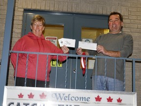 Mitchell's Julie Eidt (left) caught the ace Oct. 9 at the Mitchell Legion's Catch The Ace draw, and with it won $22,958, presented by Legion President Bob Walkom. Eidt had envelope number 36, and inside was the Ace of Spades! The next draw is scheduled to begin in early December. ANDY BADER/MITCHELL ADVOCATE