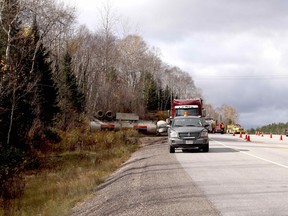 Bonfield firefighters responded to a collision, Tuesday, in which a tanker rolled into a ditch off Highway 17. Michael Lee/The Nugget