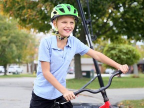 Ten-year-old AJ Hopman of Chatham raised money for the Canadian Cancer Society by riding his bike nearly 10 kilometres on Oct. 17. Mark Malone/Postmedia Network