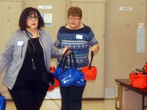 Wendy Waucaush, left, and Janine O'Neil move boxed lunches at the UAW Hall, as they volunteer at Community Living Wallaceburg's box lunch fundraiser held on Thursday, April 19, 2018. The poplular box lunch fundraiser has been cancelled for this year, organizers have announced. File photo/Courier Press