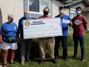 Members of the Fort Saskatchewan Rotary Club presented resident Jesse McKiernan with a cheque at his home in August, as he won the Club’s 50/50 raffle. The Rotary Club will host another raffle this winter in lieu of their annual Operation Red Nose fundraiser. Photo Supplied.