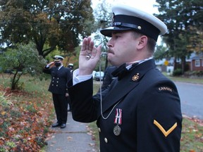 Sailor Robert Thorpe, with HMCS Prevost, pipes during a flag-raising ceremony Wednesday at the Sarnia home of Lucienne de Vries.