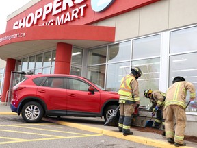 Firefighters clean up after a Mazda CX-5 struck Shoppers Drug Mart at Cambrian Mall in Sault Ste. Marie, Ont., on Thursday, Oct. 22, 2020. (BRIAN KELLY/THE SAULT STAR/POSTMEDIA NETWORK)