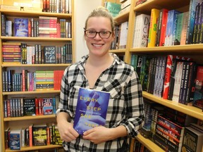 Emily Bisson, with the Lambton County Library, holds a copy at The Book Keeper in Sarnia of the new One Book Lambton title, Every Step She Takes.