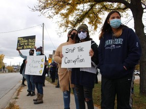 Supporters of a Sarnia police officer rally Saturday outside the city's police headquarters.