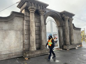 Crew member Casey Stranges strolls past a set for the Resident Evil movie on Monday. The temporary piece of architecture was erected in a parking lot behind the Ledo Hotel as the production moved to downtown Sudbury to shoot some scenes. Jim Moodie/Sudbury Star