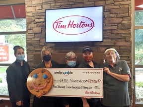 At the presentation of money raised during this year's Smile Cookie campaign at the Wiarton and Hepworth Tim Hortons are, from left, Michelle Preston, owner of the Wiarton and Hepworth Tim Hortons Restaurants; April Patry, Executive Director of Bruce Peninsula Health Services Foundation and staff of the Wiarton Tim Hortons restaurant.