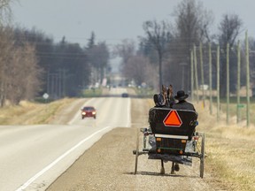 A horse-drawn buggy heads north along a country road south of Listowel earlier this year. Mike Hensen/Postmedia Network
