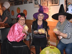 Volunteers helped hand out popcorn balls at last year's Creepy Crawly Halloween Hoopla.