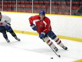 Nick DeGrazia, right, carries the puck while Gio Biondi defends during a practice session at Garson Arena in Garson, Ontario on Wednesday, October 14, 2020.