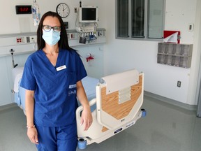 Registered nurse Emma Holmes stands next to a bed in the regional intensive care unit at Belleville General Hospital in August. New provincial funding will help to fund the unit's expansion and upgrades to three beds as well as the opening of non-acute-care beds elsewhere in QHC's hospitals. Luke Hendry/The  Intelligencer/Postmedia Network