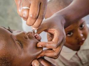 A child receives a polio vaccination drop during the nationwide vaccination campaign against measles, rubella and polio targeting all children under 15 years old in Nkozi town, about 84 km from the capital Kampala, on October 19, 2019. PHOTO BY BADRU KATUMBA / AFP