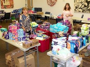 Marge Muharrem (left), staff support for Women United, and Patty Peters, resource director for the United Way of Chatham-Kent, were busy sorting through the $16,000 worth of feminine hygiene products that were donated for Tampon Tuesday. Ellwood Shreve/Postmedia Network