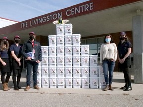 The Rapid Relief Team in Tillsonburg recently donated 40 boxes of non-perishable food to the Oxford County Community Health Centre. From left are Rapid Relief Team volunteers Kaitlyn Carpani, Kiara Prince, Roland Shaw, and Mikayla Shaw (far right) with Abbie Boesterd, OCCHC outreach worker. (Chris Abbott/Norfolk and Tillsonburg News)