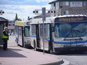 City buses are parked alongside 99 Street in Grande Prairie, Alta. on Saturday, Aug. 29, 2020.